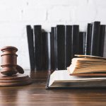 A gavel next to some open law books including one on business litigation