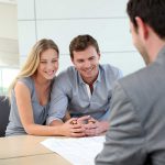 Young man and woman smiling as they discuss estate planning for unmarried couples with an Orlando attorney