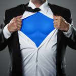 Young businessman acting like a super hero and tearing his shirt like Superman turning him into a "Super Lawyer"
