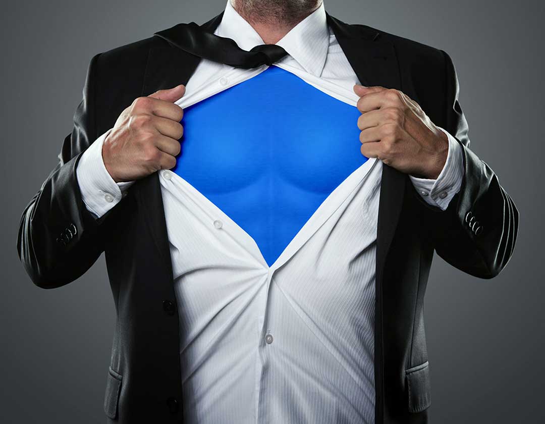 Young businessman acting like a super hero and tearing his shirt like Superman turning him into a "Super Lawyer"