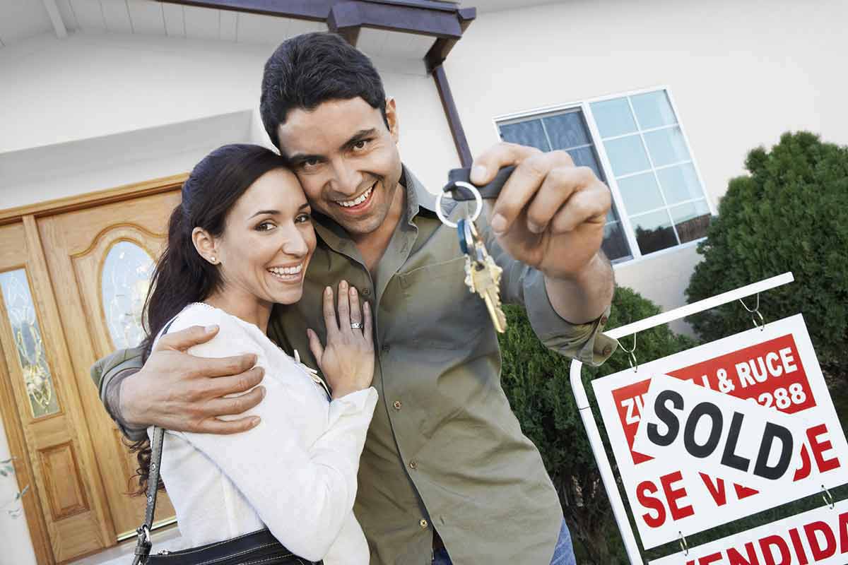 Happy Homeowners with Sign