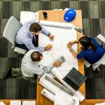 business partners looking tense as they sit at a table trying to work out a disagreement about their business