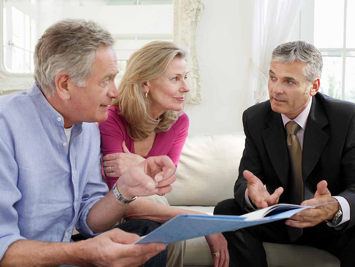 Attorney talking to an adult couple going over their living trust