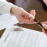 Attorney examining real estate closing documents with a client