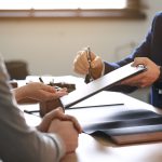 Attorney and family reviewing an estate administration checklist at a conference table
