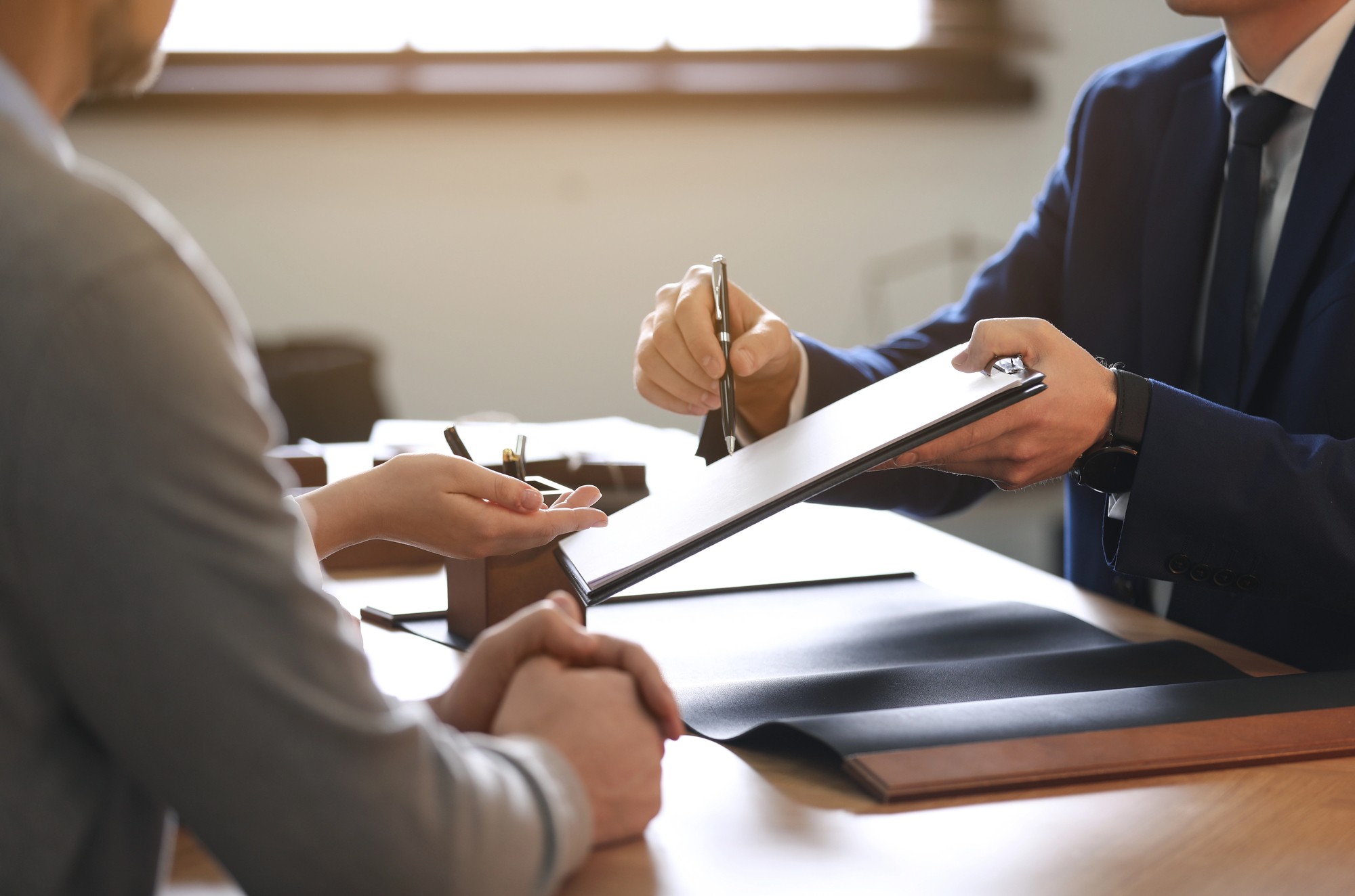 Attorney and family reviewing an estate administration checklist at a conference table
